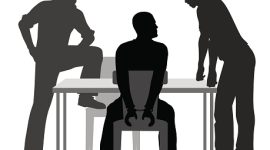 Editable vector silhouettes of a handcuffed man being interrogated by two detectives